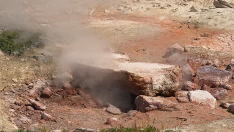 Closeup-of-steam-rising-from-underneath-rock-in-Yellowstone-National-Park