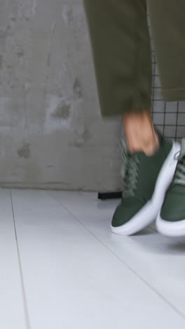 person walking in green sneakers