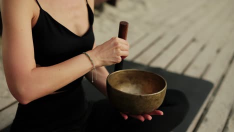 Unrecognizable-woman-with-tibetan-singing-bowl-for-yoga-and-meditation