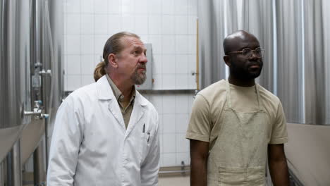 two workers talking at the factory