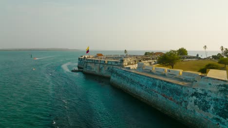 aerial drone shot of the fort and castle of san luis de bocachica leaving to the ocean in cartagena, colombia