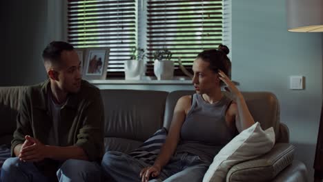 couple sitting on a sofa having a conversation
