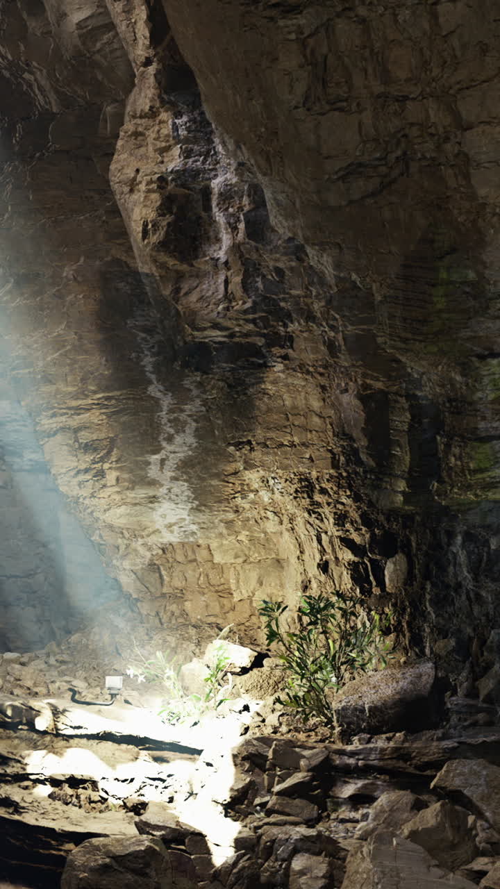 Light beams streaming through a cave with rugged stone formations