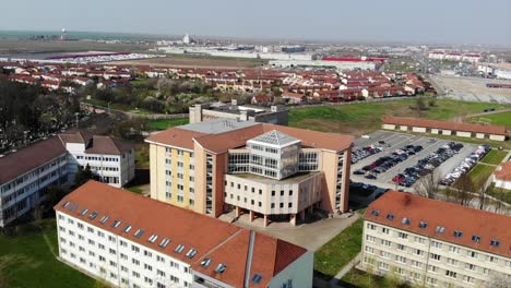 aerial drone shot over universitatea oradea campus library parking big building with students