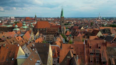 4k aerial drone video of the copper-clad cupolas on the beautiful sebalduskirche church in downtown nurnberg, germany