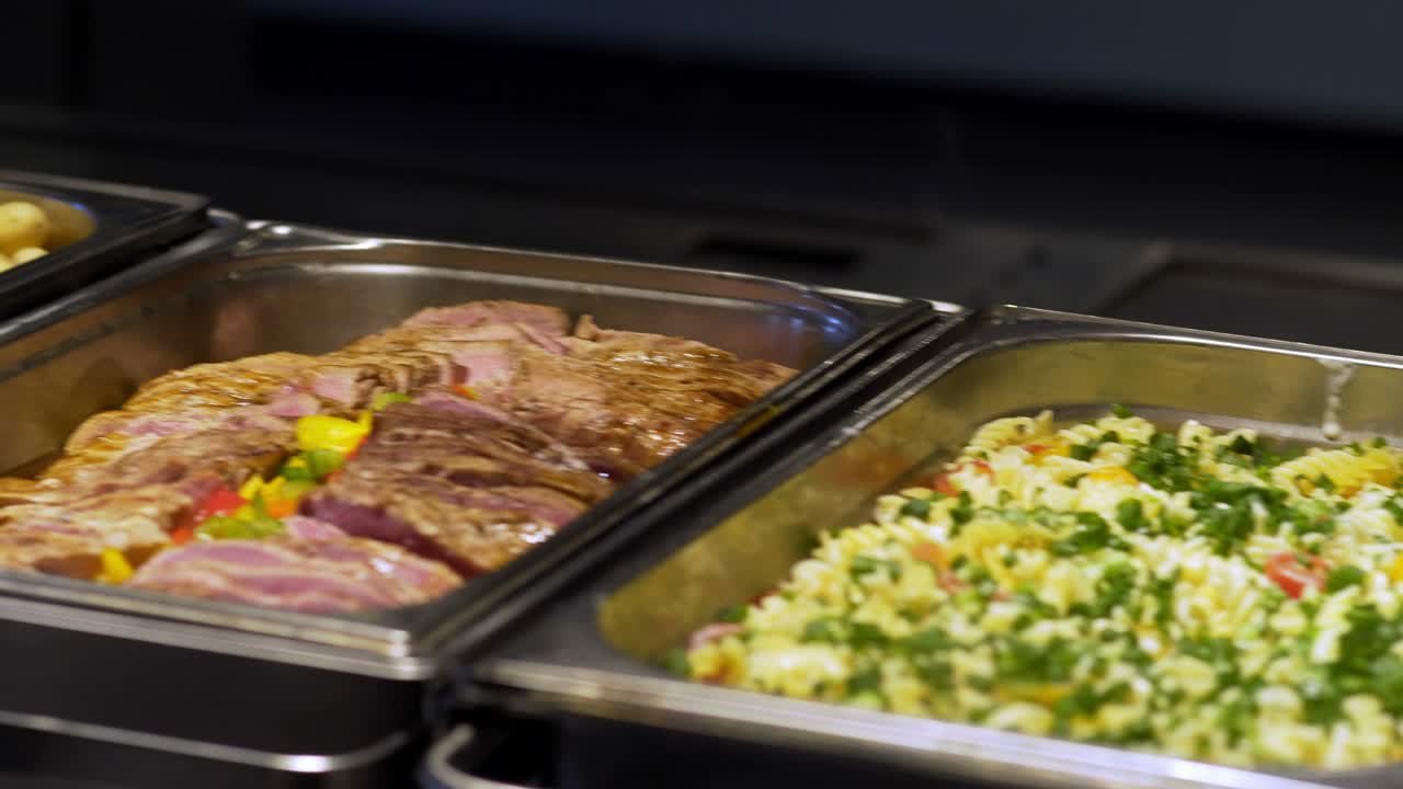 los huéspedes del restaurante eligen la comida de un buffet