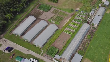 aerial view of a farm with greenhouses and vegetable gardens
