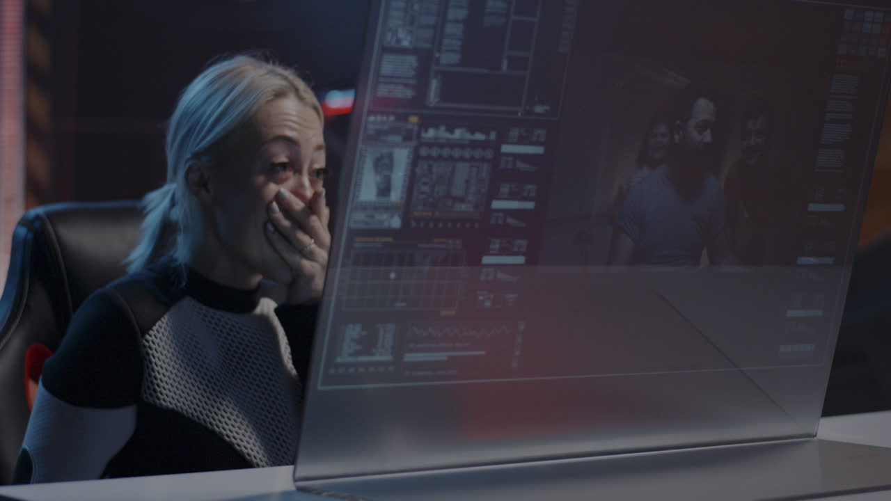 Woman reacting emotionally to a video call on a futuristic computer