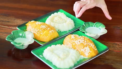 pouring coconut milk over mango sticky rice