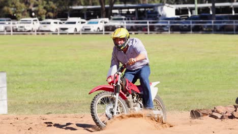 motorcyclist navigating through a dirt track course