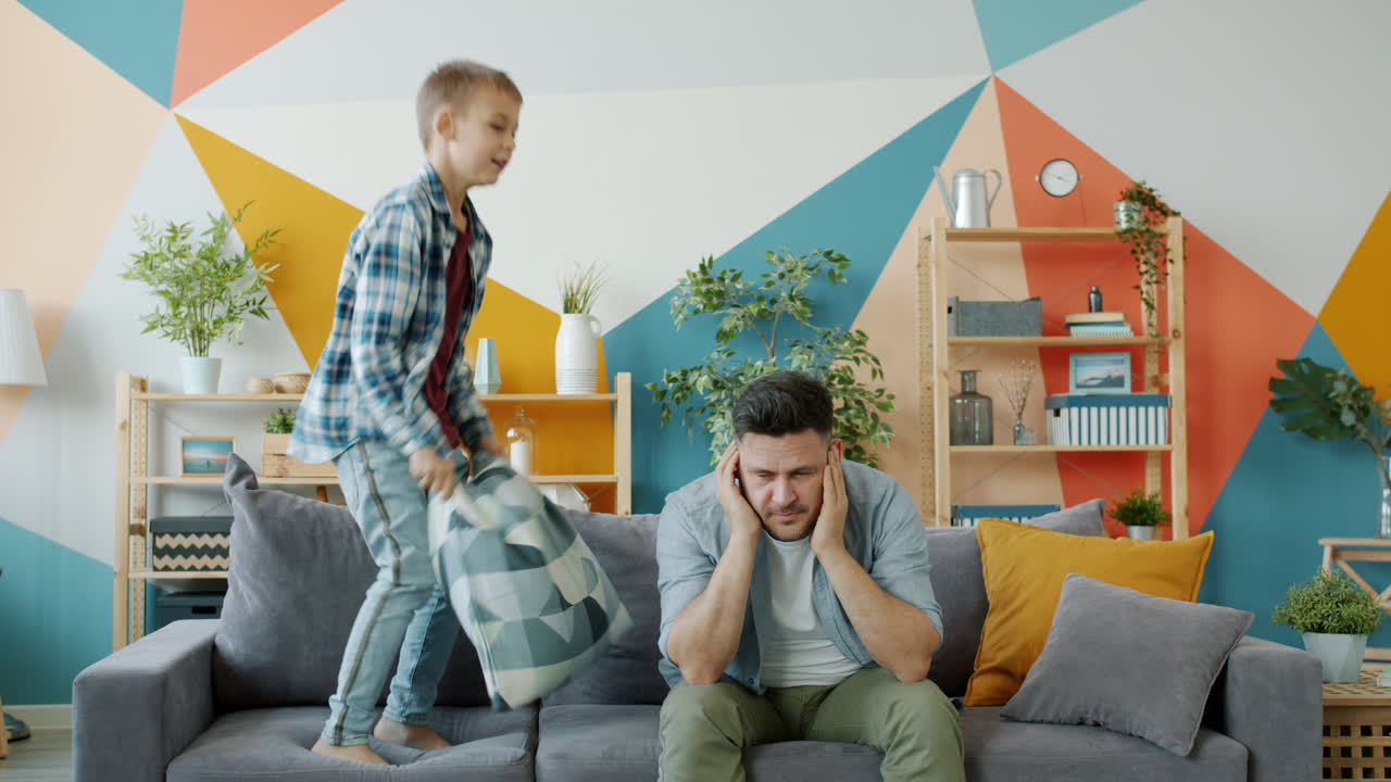Boy Pillow Fighting With Dad