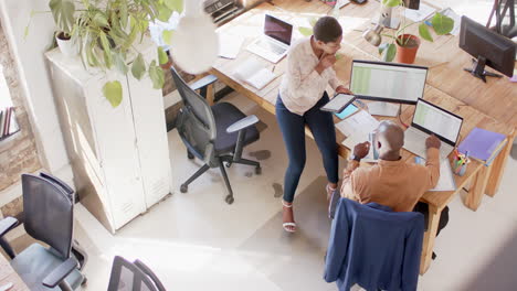 Young-African-American-business-couple-collaborates-in-a-modern-office-with-copy-space