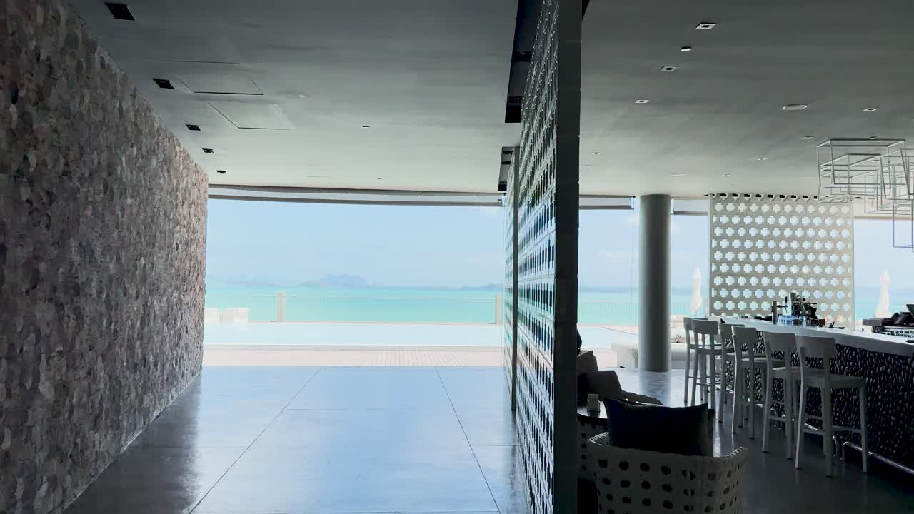 A tranquil walkthrough of a luxury resort in Phuket, showcasing modern architecture and stunning ocean views under natural lighting