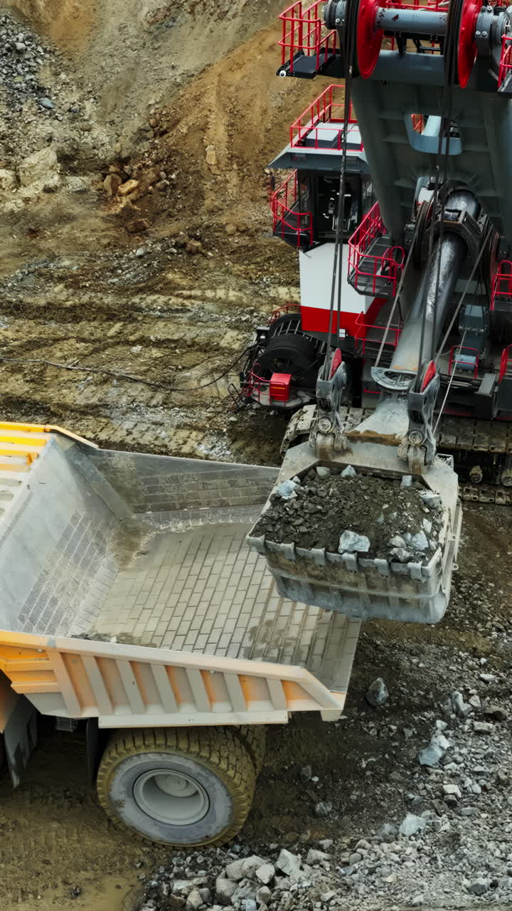 Large Excavator Loading a Dump Truck in a Quarry