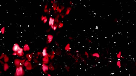 Animation-of-confetti-and-red-hearts-falling-on-black-background