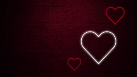 animation of red and white neon hearts flashing on dark brick wall