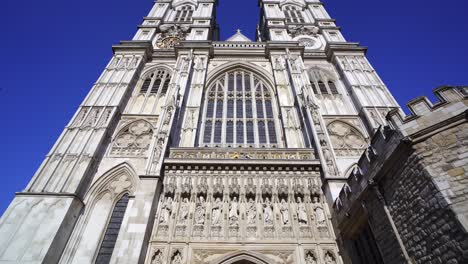 tilting shot revealing the impressive gothic west front of westminster abbey in london, england