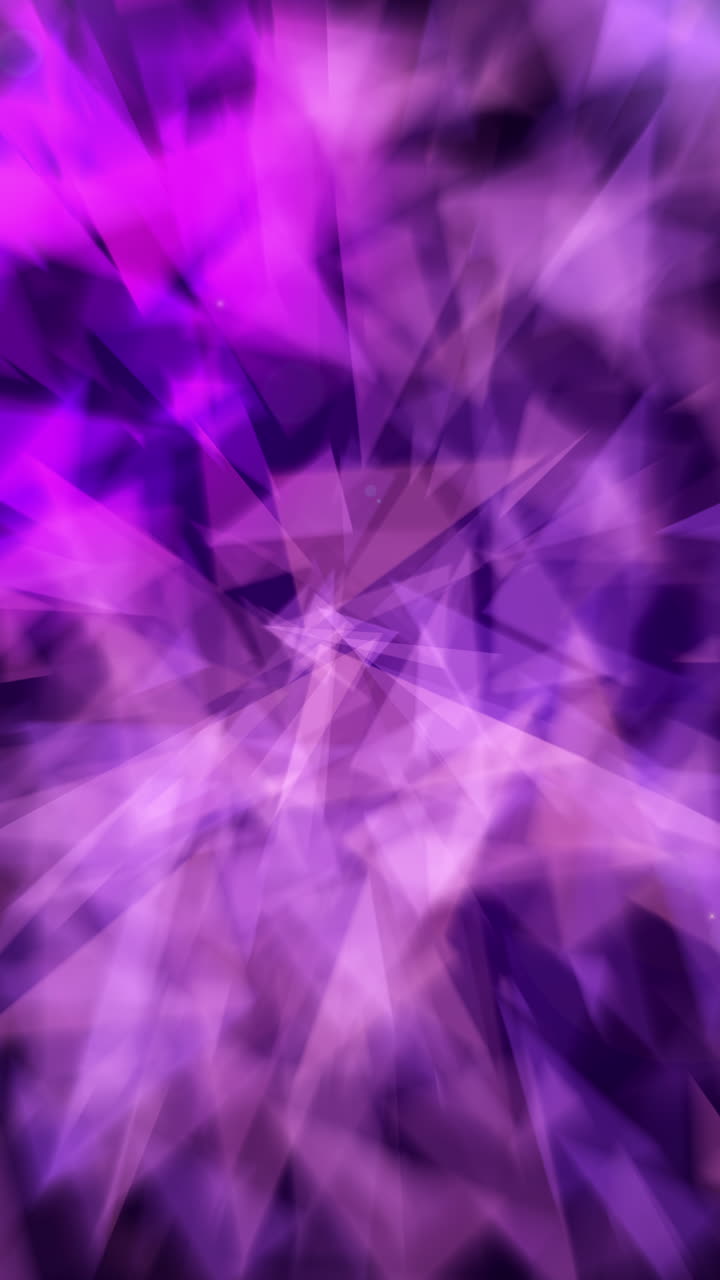 Abstract purple triangles shape animated on a black background. Looped blurry animation. Vertical video.