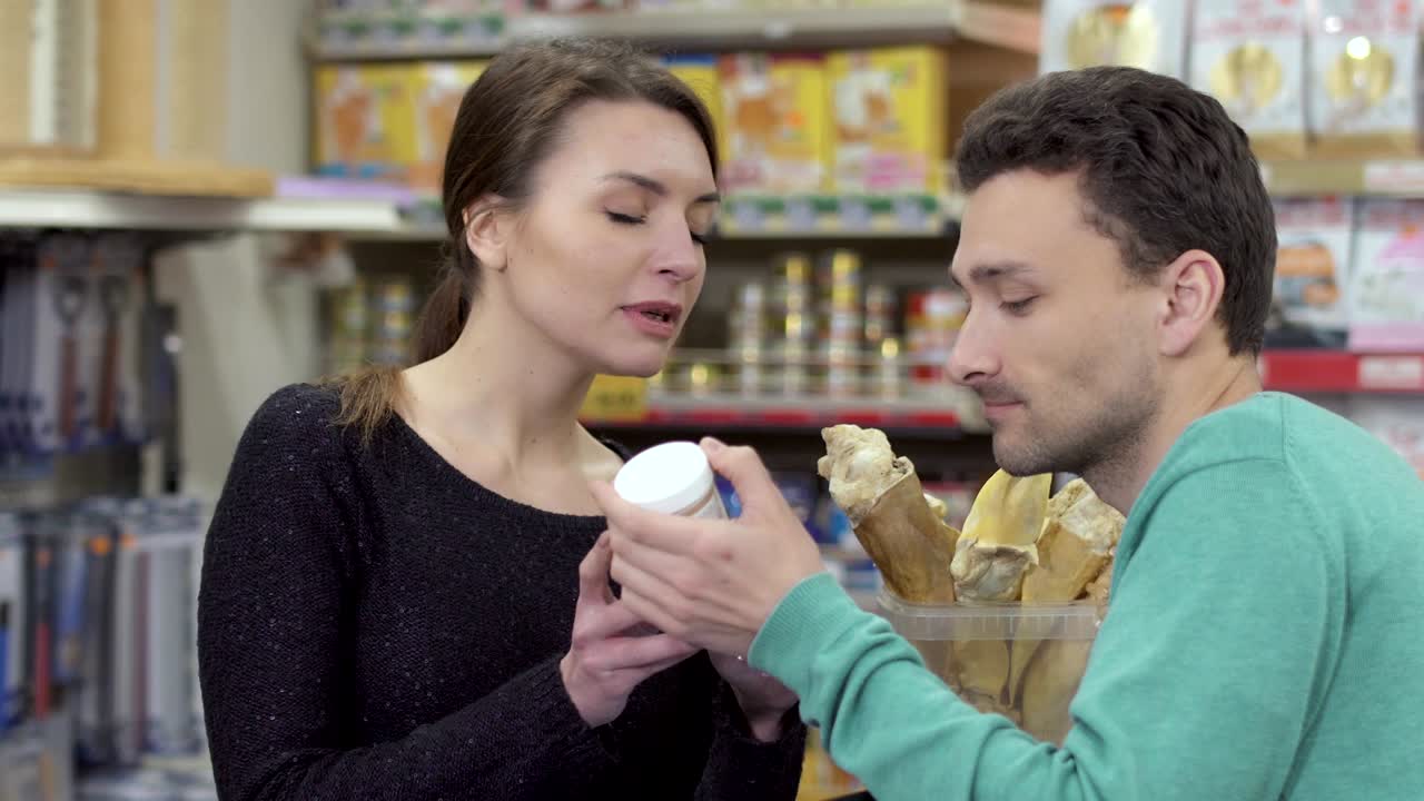 el comprador pide información al vendedor sobre el producto en la tienda de mascotas