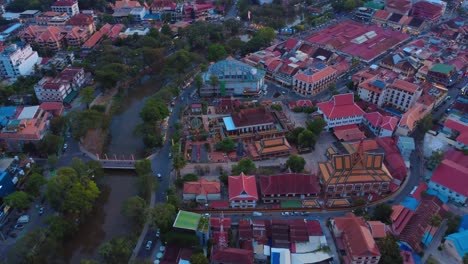 siem reap city, showing busy streets, rooftops, and river canals, aerial view