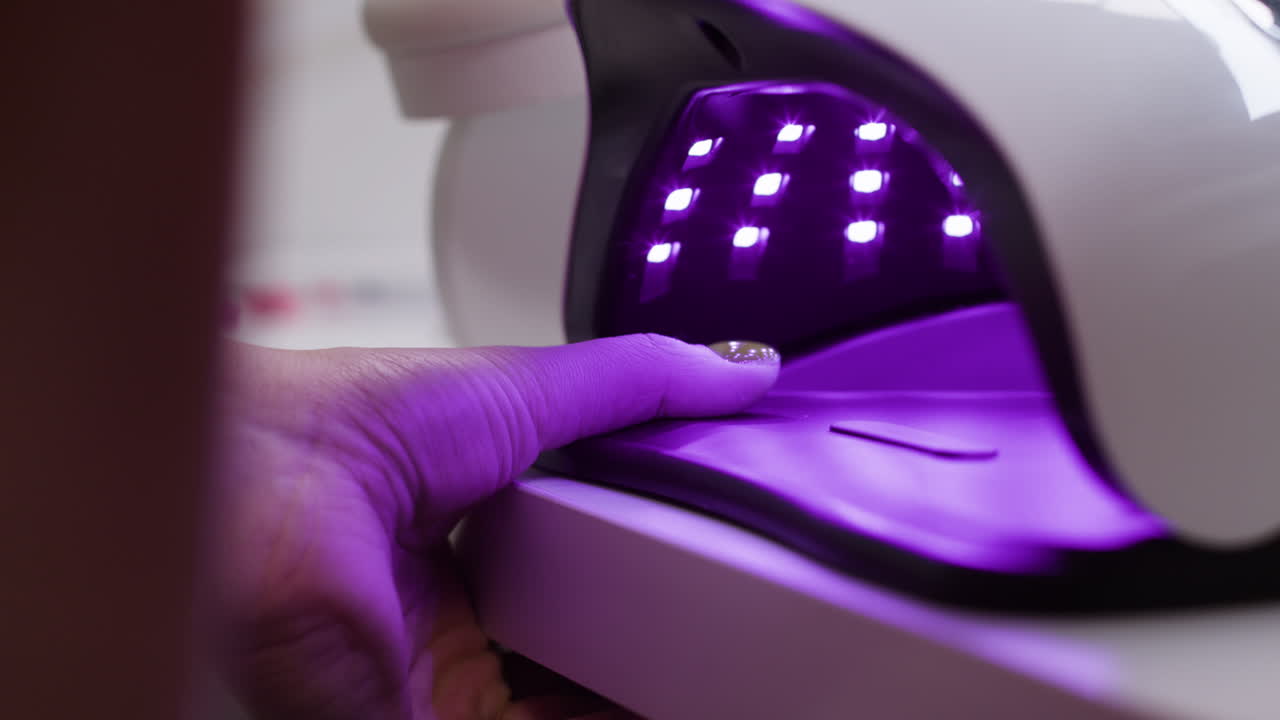 Applying nail polish and curing with a UV lamp