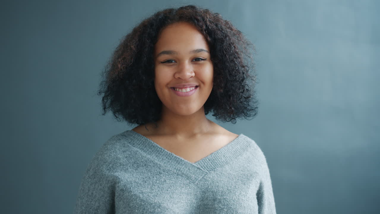 Smiling young woman waving
