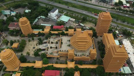 drone shot flying in over a large buddhist temple or pagoda in ho chi minh city, vietnam