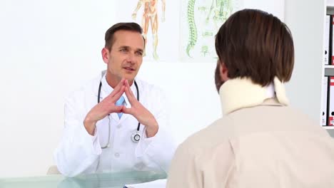 Doctor-speaking-with-his-patient-in-a-neck-brace