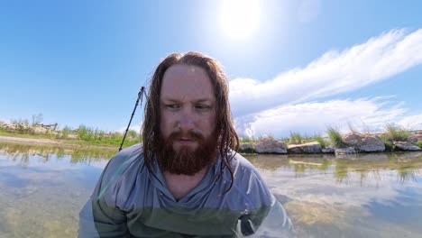 hot spring in utah with a red haired male sitting confused in water