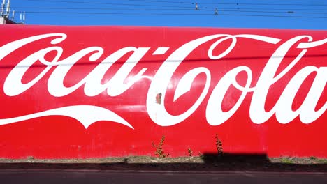 Coca-Cola Logo on a Large Red Wall