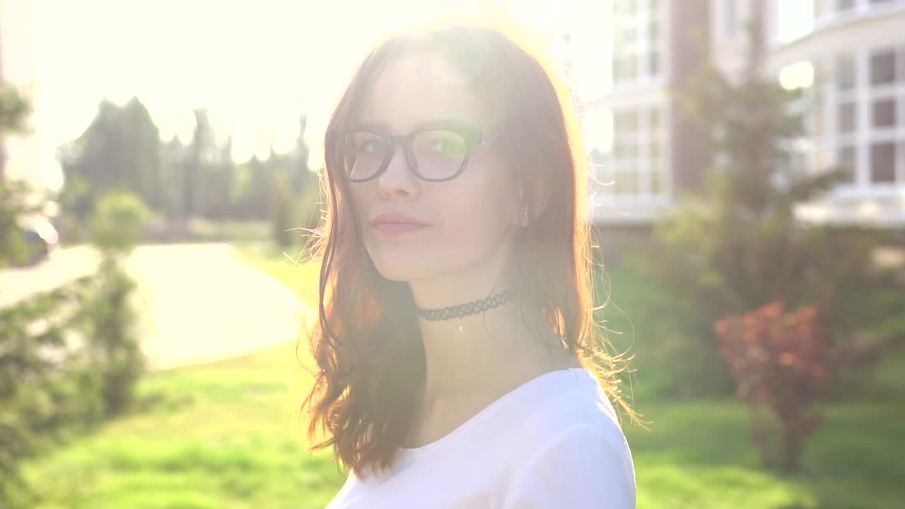 Young woman in glasses outdoors