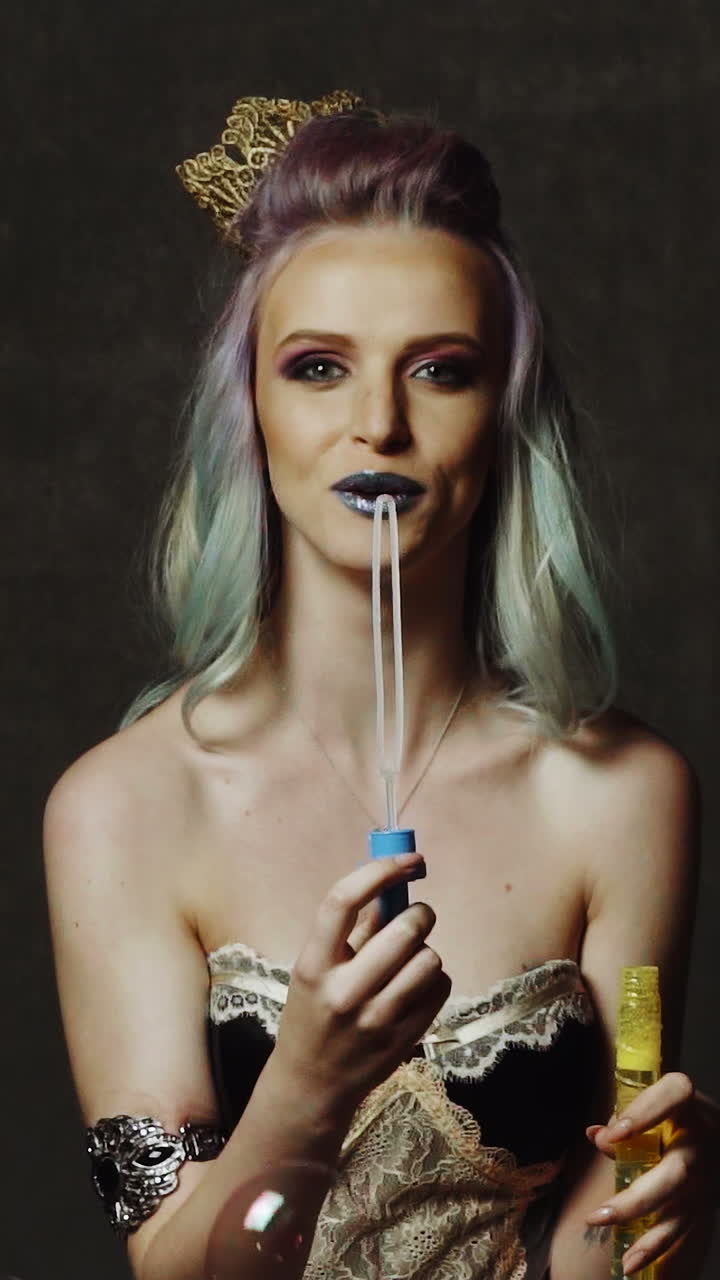 Woman with bubble. Young girl having fun with bubbles in studio