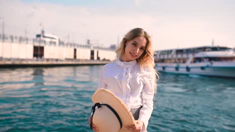 slow motion:beautiful girl poses near bosphorus with view of galata bridge and istanbul