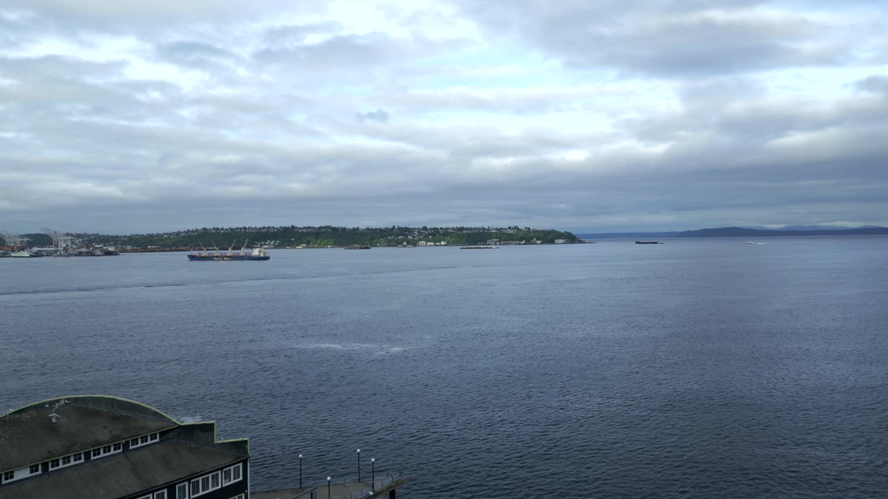 Picturesque aerial view of calm ocean bay waters and idyllic cloudscape along Seattle Waterfront coast - Seattle, Washington, USA