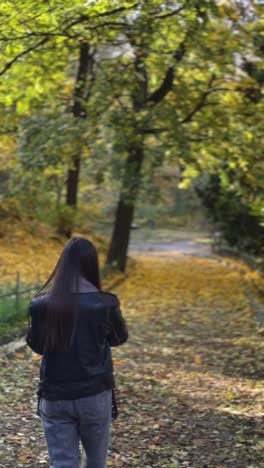 woman walking in autumn park