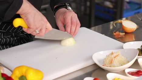 chef cutting an onion
