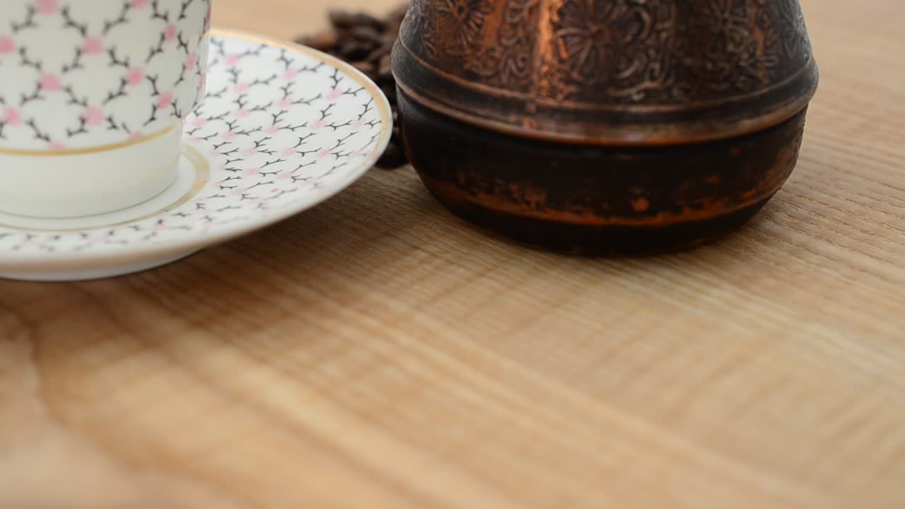 Closeup of Coffee, coffee cup and grains. Shooting in the movement