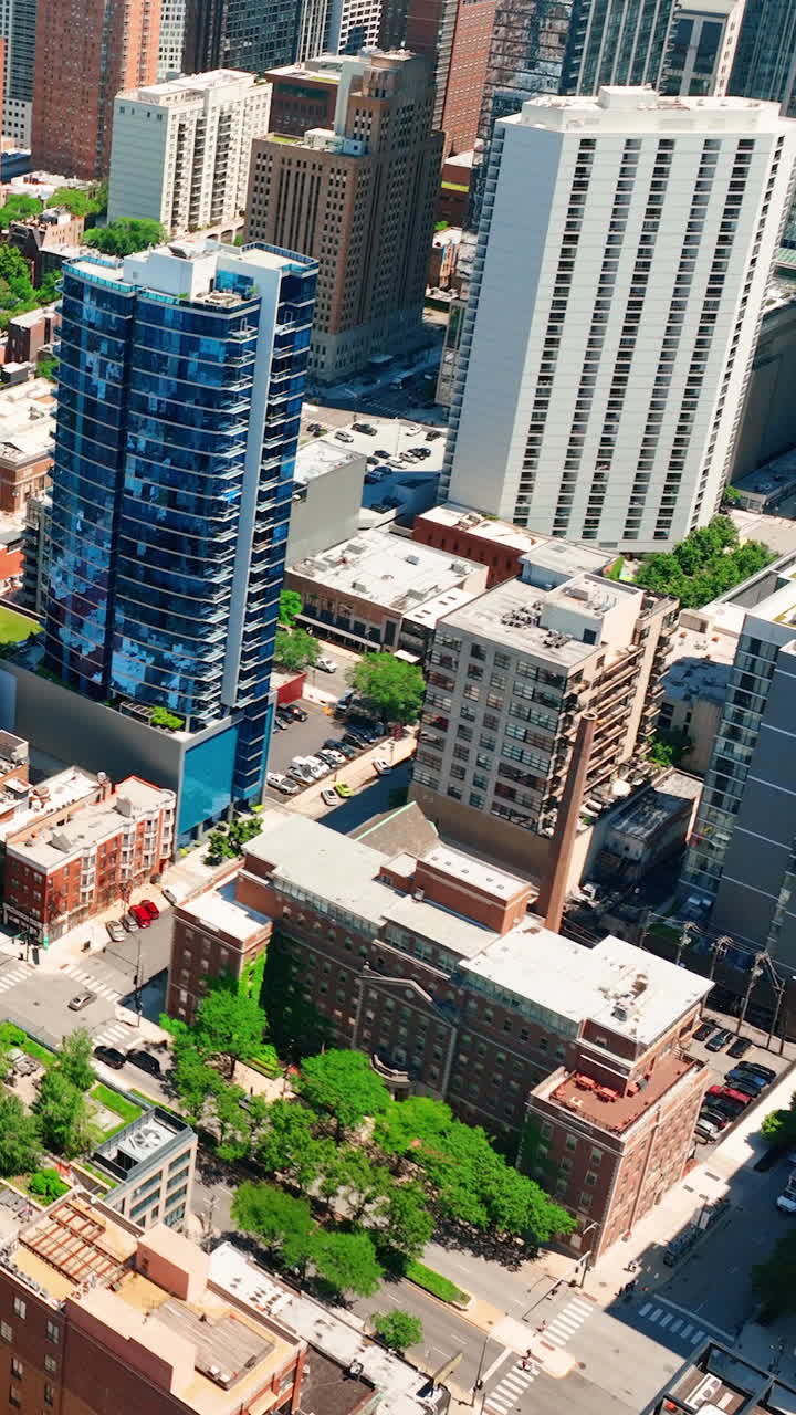 Chicago, Illinois, USA aerial cityscape with high rises in the sunny day. A tall building made of blue glass. Aerial view. Vertical video