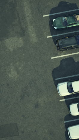 birds eye view of a parking lot with various cars in daytime