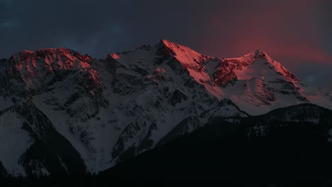 4k timelapse of clouds moving through the snowy rocky mountains