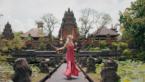 travel woman dancing in saraswati temple celebrating culture of bali indonesia 4k