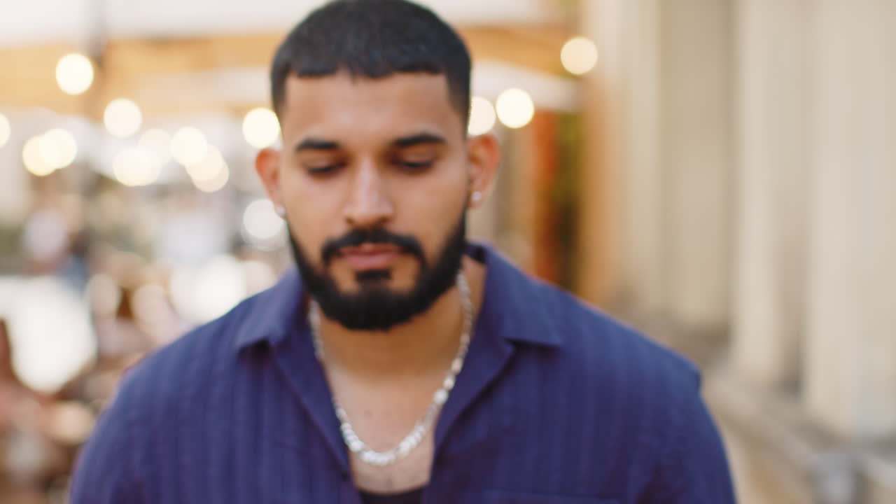 Happy young man smiling looking away dreaming resting good news feel satisfied in city street