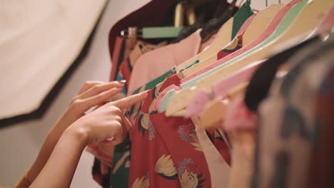 woman checking clothes on the hangers