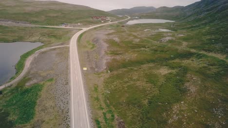 Tilt-up-while-moving-sideways-drone-shot-next-to-lakes-and-hills