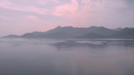 steady aerial drone footage of zlatar lake with beautiful clouds above