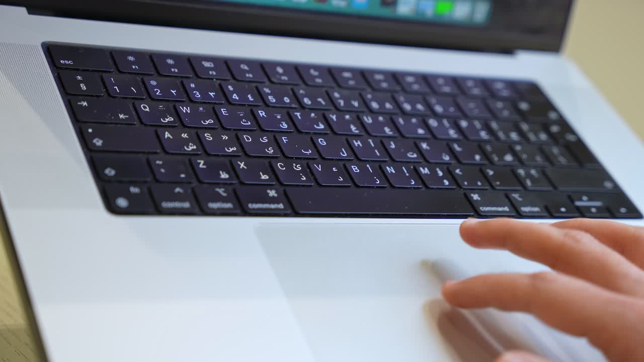 Close-up shot of hands typing on an Arabic-English bilingual keyboard—perfect for language, tech, education, and global work concepts.