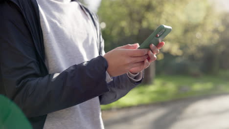 hands, smartphone and texting in park