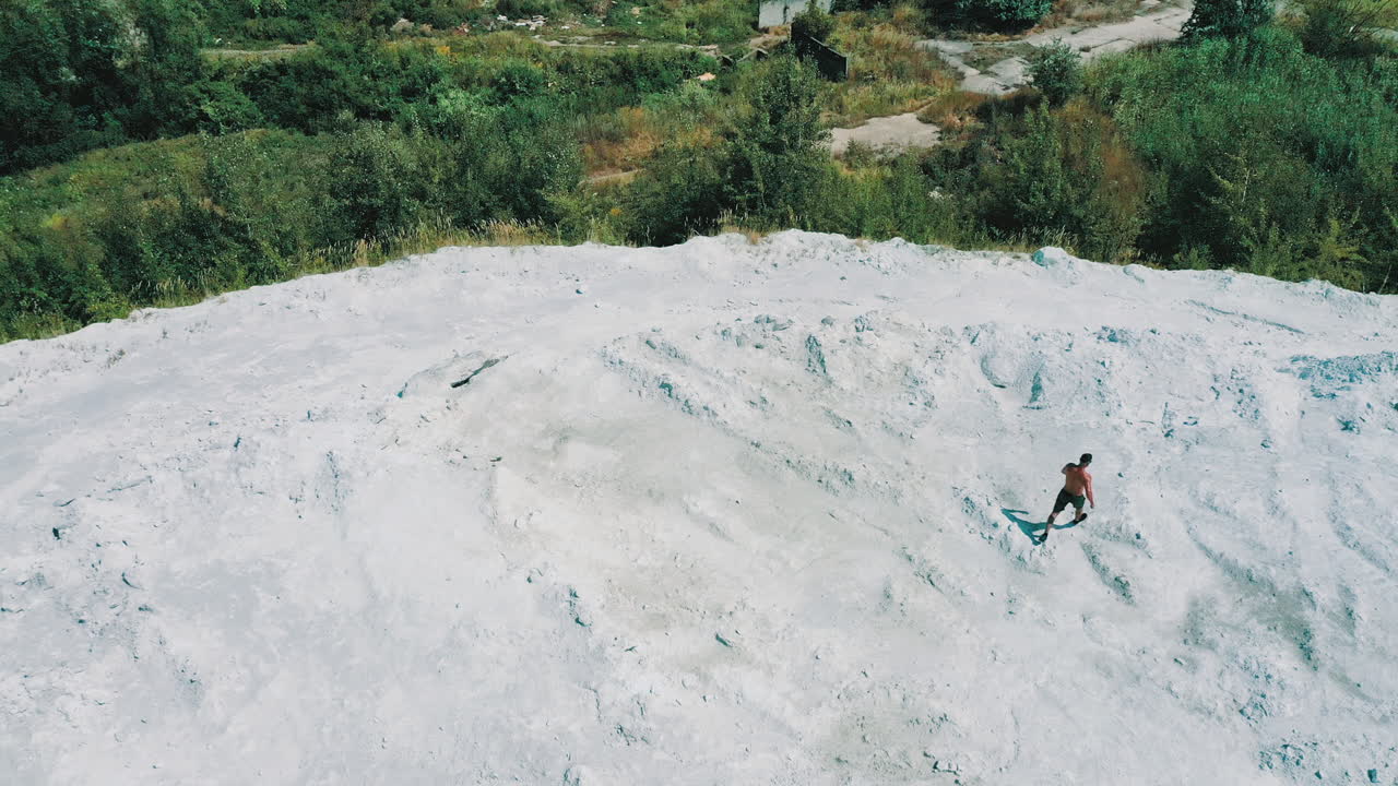 Man training cardio, top view. Aerial view of sportive man running on nature