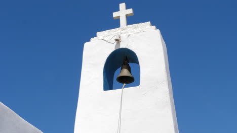 Bell-and-cross-of-greek-orthodox-church-Agios-Nikolas-Chapel,-close-up