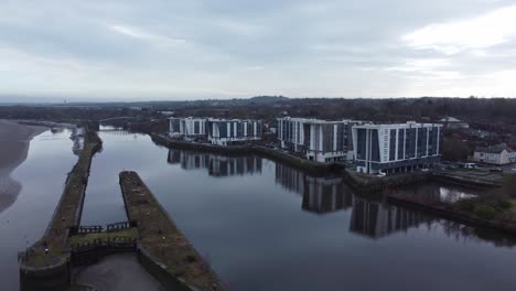 early morning aerial view riverside waterfront contemporary apartment office buildings canal regeneration real estate orbit left wide